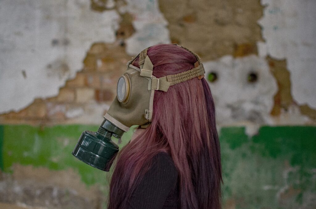 woman in red hair wearing gas mask